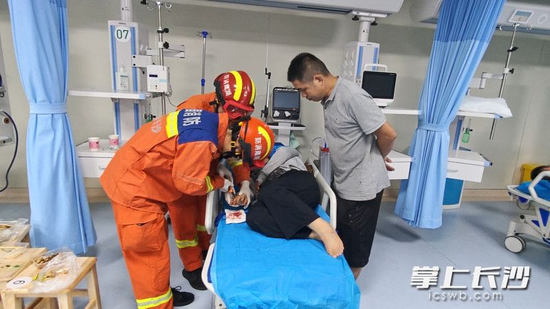 消防员为病床上的市民取戒指。 长沙晚报通讯员 王磊 摄 消防员为病床上的市民取戒指。 长沙晚报通讯员 王磊 摄