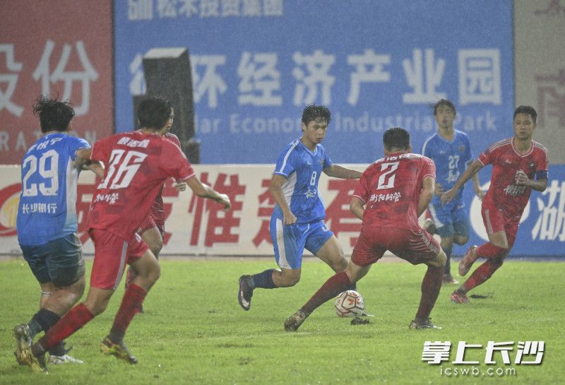 双方球员在大雨中作战。