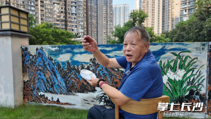 9月9日，严先生正在小区内翻新自己4年前创作的墙画。 均为长沙晚报全媒体记者孙占锋 通讯员 付朝俐 摄